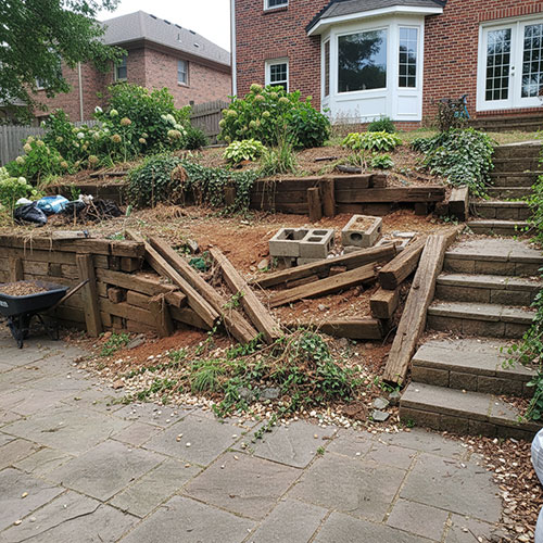 decaying timber retaining wall before